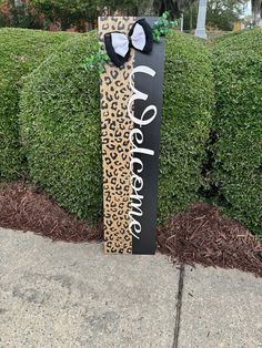 a skateboard with the word adventure on it sitting in front of a bush and bushes