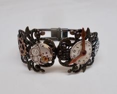 "Awesome steampunk cuff bracelet made of a clock gears, watch movement mounted on a brass Victorian filigree cuff. The size is 6 1/2\" and the top open by pushing sideways, it has a hinge on the bottom.  More steampunk bracelets in my shop www.etsy.com/shop/slotzkin" Vintage Adjustable Cuff Watch, Vintage Cuff Watch, Steampunk Adjustable Quartz Watch, Adjustable Metal Bracelet Watch, Adjustable Steampunk Copper Jewelry, Adjustable Copper Steampunk Jewelry, Adjustable Bronze Steampunk Jewelry, Victorian Filigree, Steampunk Bracelet