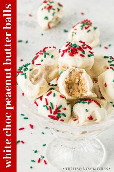 white frosted donuts with sprinkles in a glass bowl on a table