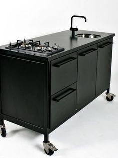 a black kitchen island with two sinks on wheels