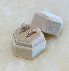 an engagement ring in a box on a fur surface