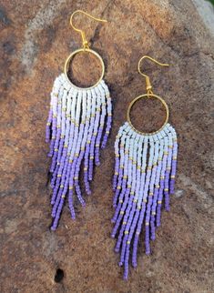 These beautiful handmade purple and white seed bead fringe earrings are sure to be the statement piece of your outfit. The perfect accent for any occasion. Made with high quality round glass seed beads, hypoallergenic earring hooks and lots of love. Earrings are 4.25 inches long from ear lobe and 1.25 inches  wide. Pair pictured is completed and will ship within 3-5 business days.  Please reach out with questions or custom earring requests.  *Purchase 3 items from Color My World Artistry and automatically receive 15% off your order.* Purple Fringe Beaded Earrings As Gift, Purple Fringe Beaded Earrings For Gift, Purple Earrings With Beaded Fringe, Purple Jewelry With Beaded Fringe And Round Beads, Purple Beaded Fringe Earrings For Festivals, Bohemian Lavender Beaded Dangle Earrings, Purple Beaded Earrings With Tassels, Handmade Purple Tassel Earrings With Round Beads, Purple Beaded Earrings With Round Beads For Festival