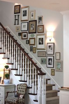 a staircase with many framed pictures on the wall