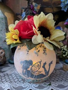 a vase with some flowers in it on a table