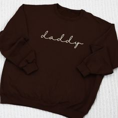 Celebrate parenthood with our daddy Sweatshirt. This cozy sweatshirt is perfect for dad or soon to be dads. Show your love and appreciation with this great gift idea. Get yours today! We primarily use unisex Jerzee Nublend sweatshirts. Matching embroidered mama and daddy sweatshirts mama versions available here Pre-shrunk Listing picture is chocolate sweatshirt with cream thread - ( matches closest to our sandstone sleepers 1x1 Ribbed collar, cuffs, and waistband with spandex Double-needle stitc Family Matching Crew Neck Sweatshirt For Father's Day, Father's Day Cotton Crew Neck Sweatshirt, Father's Day Long Sleeve Relaxed Fit Sweatshirt, Father's Day Relaxed Fit Letter Print Sweatshirt, Father's Day Letter Print Relaxed Fit Sweatshirt, Father's Day Letter Print Sweatshirt, Casual Crew Neck Sweatshirt For Father's Day, Family Cotton Crew Neck Sweatshirt, Father's Day Casual Sweatshirt With Name Print