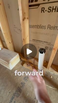 a person is working on the framing for a house under construction with wood and insulation tape