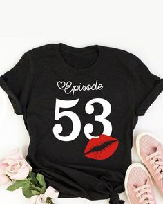 a t - shirt with the number 55 on it next to some flowers and shoes