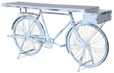 an old fashioned bicycle with a table on it's front wheel is shown against a white background