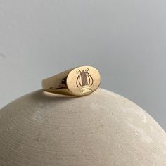 Madison designed this signet ring style specifically for the Fewer Finer collection. She deems the shape perfect for a classic signet style because it is proportionally sound and beautifully finished in a mix of smooth and matte. The signet ring is classically beautiful whether left alone or enhanced with a monogram, an engraving or stones. This style is unisex, and looks great on men and woman. For inspiration, check out some examples of how others engraved this piece here! Classic Oval Ring With Timeless Design, Timeless Oval Dome Ring Stamped 14k, Oval Ring With Timeless Design For Anniversary, Elegant Yellow Gold Ring With Engraving Option, Minimalist White Gold Ring With Engraving Option, Elegant Yellow Gold Engraved Ring, Timeless Engraved Yellow Gold Ring With Classic Design, Timeless Yellow Gold Engraved Ring With Classic Design, Elegant Engraved Ring In Recycled Gold For Formal Occasions