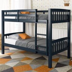 a bunk bed with two sets of mattresses on top of it in a room