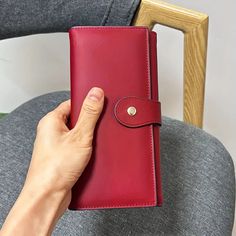 This spacious and stylish leather wallet can hold your phone, checkbook, cards, coins and cash. Snap closure; 12 card slots; 3 ID slots; 2 slip pockets; zip pocket; 2 full-width open pockets. Dimensions: 7 1/4"W x 4"H x 1"D Available in black and red. Cash Snap, Dressy Earrings, Bag Icon, Slipper Socks, Guitar Strap, Dress Hats, Travel Wallets, Travel Tote, Shoulder Tote