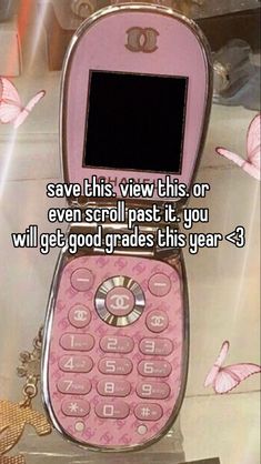 a pink cell phone sitting on top of a table next to a butterfly wallpaper