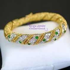 Pretty sparkly diamond weaved 18k yellow gold bracelet with mesmerizing emerald accents! The bracelet opens and closes with a latched clasp.Total Weight: 50 gramsBracelet length: 6.5 inchesPrecious Metal: 18k yellow goldPrecious stones:-Emerald Cabochons: 1.5mm to 2.8mm, 0.8 carats-White Round Diamonds: 3 carats Elegant Yellow Gold Bracelet With Emerald, Elegant Yellow Gold Emerald Tennis Bracelet, Luxury Green Gold Bracelet For Anniversary, Elegant Gold Emerald Tennis Bracelet, Elegant Yellow Gold Diamond And Emerald Bracelet, Luxury Green Bangle For Anniversary, Yellow Gold Emerald Bangle Bracelets, Yellow Gold Emerald Bangle Bracelet, Formal Emerald Bangle