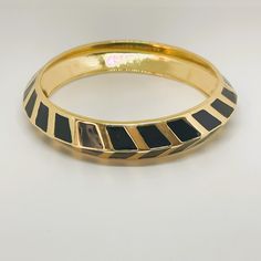 VINTAGE VINCE CAMUTO BLACK ENAMEL AND GOLD BRACELET.  THIS BRACELET SLIPS ON THE ARM AND IS 2.5 INCHES WIDE.  THIS IS A VINTAGE 90'S BLACK ENAMEL AND GOLDTONE BRACELET.  THIS BRACELET IS STURDY AND MADE FROM METAL.  THIS BRACELET IS SIGNED VINCE CAMUTO, PLEASE SEE PICTURES.  THIS ITEM IS VINTAGE AND IN EXCELLENT CONDITION, READY TO WEAR.  Note:  All items are accurately described.  Colors may vary depending on what you are viewing the item on.  If you have questions regarding color of an item, p Luxury Yellow Gold Bracelets With Black Enamel, Black Minimalist, Designer Bracelet, Gold Armband, Enamel Bangle, Minimalist Bracelet, Bracelet Black, Bracelet For Women, Black Enamel