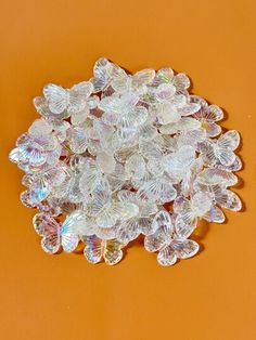 a pile of glass beads sitting on top of an orange surface