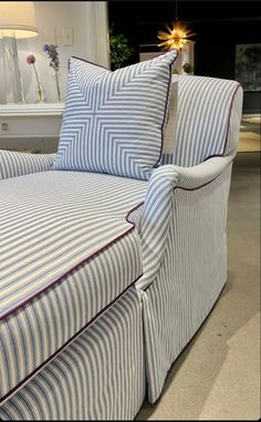 a blue and white striped couch with pillows