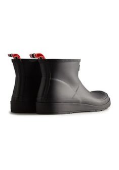 The PLAY Short Rain Boots from Hunter are a playful and practical choice for women. Crafted from the highest quality natural rubber, these boots are 100% waterproof and feature a 100% recycled polyester lining for added comfort. The pull tab allows for easy foot entry, while the flatter platform sole provides all-day comfort. With a design that grazes the top of the ankle, these boots are perfect for any occasion. | Hunter Women's PLAY Short Rain Boots, Black, 7M Black Waterproof Boots With Recycled Rubber, Black Waterproof Boots Made Of Recycled Rubber, Short Rain Boots, Women Hunters, Pull Tab, Boots Black, Natural Rubber, Rain Boots, For Women