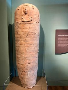 a large stone object on display in a museum