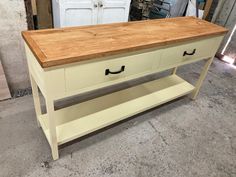 a table with two drawers on top of it in a room filled with other items