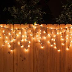 a wooden fence with lights on it