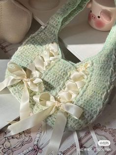 a pair of baby shoes with bows on them