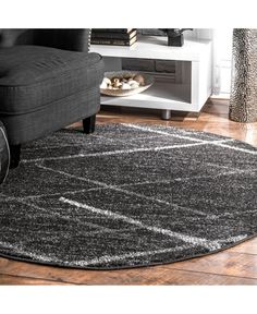 a living room with a black chair and rug