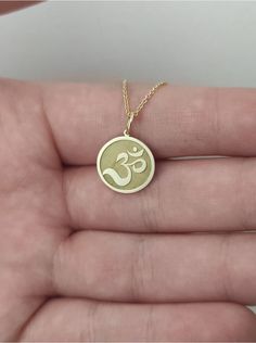 WE SHIP YOUR PARCEL IN ONE DAY! (Processing time - 1 Day, Estimated Delivery once Shipped - 3-5 business days) Engraved Om Design Necklace - Om Pendant Necklace - Handmade Om Gold Jewelry - Engraved Om Gold Necklace Engraved Om Pendant Necklace made out of 14K Solid Gold. Available in Yellow Gold, White Gold, or Rose Gold finish. An elegant piece of jewelry that is a perfect gift to yourself and your loved ones. Add your engraved personalization at the back of the pendant. Contact us with a clea Spiritual 14k Gold Personalized Charm Necklaces, Spiritual 14k Gold Round Pendant Jewelry, Spiritual 14k Gold Round Pendant, 14k Gold Spiritual Round Pendant Jewelry, Personalized 14k Gold Spiritual Charm Necklaces, Personalized 14k Gold Spiritual Charm Necklace, Spiritual Round Charm Necklace In 14k Gold, Spiritual Round 14k Gold Charm Necklaces, Spiritual 14k Gold Round Charm Necklaces