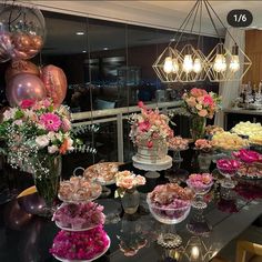 a table topped with lots of different types of flowers and desserts on top of it