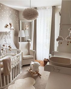 a baby's room decorated in white and gold