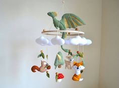 a mobile with animals hanging from it's sides in the shape of a dragon