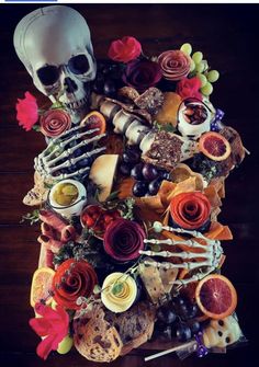 a skeleton is surrounded by food and flowers