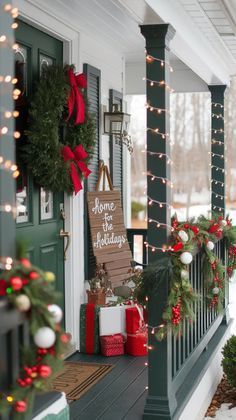 a porch decorated for christmas with wreaths and lights