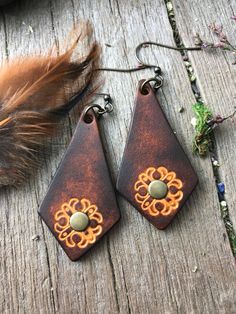 "This listing is for 2\" drop length hand kite shaped leather earrings. Hand tooled geometric design and hand dyed in a rich chocolate brown with a gorgeous contrasting caramel brown. Antiqued brass findings. Rustic and warm to go with all of your vintage styles. MADE TO ORDER. Unusual kite shape, 2\" drop. Pair these with your vintage and Bohemian styles." Leather Diy Earrings, Unique Brown Festival Earrings, Earthy Brown Earrings For Festivals, Vintage Brown Earrings For Festivals, Artisan Brown Teardrop Earrings, Handmade Leather Brown Earrings, Handmade Brown Leather Earrings, Rustic Brown Hand Tooled Earrings, Rustic Brown Hand-tooled Earrings