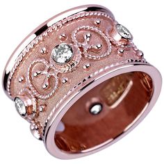 a rose gold ring with diamonds on it