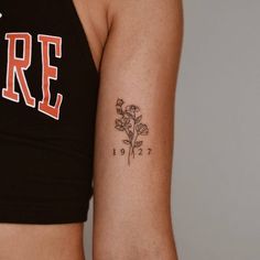 a woman's arm with a tattoo on it that reads fire and has a rose