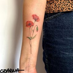 a woman's arm with red flowers on it