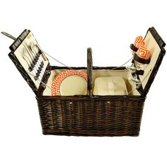 a wicker picnic basket with plates, utensils and other items in it