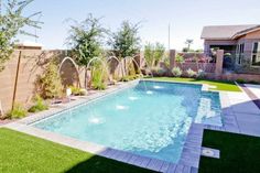 a backyard with a pool and artificial grass