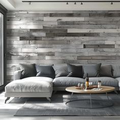 a living room filled with furniture and a large wooden wall behind the sectional couches