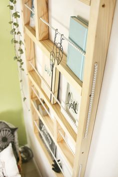 a book shelf filled with books next to a wall mounted clock and other items on top of it