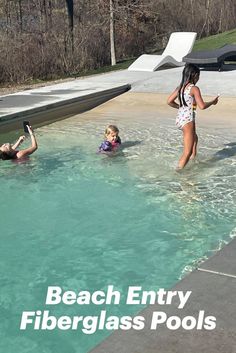 two women and a child are playing in the pool