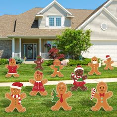 gingerbread man and woman yard decorations in front of a house