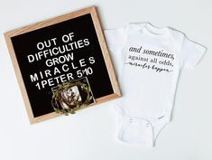 two baby onesuits are next to a sign that says out of difficulties grow miracles 1 peter 5 10