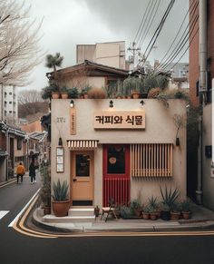 a small building with plants on the outside