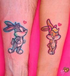 two people with matching tattoos on their arms, one has a rabbit and the other has a fox