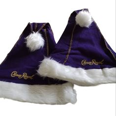 two purple and white hats with gold lettering on them, one is wearing a santa claus hat