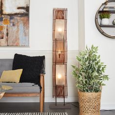 a living room filled with furniture and a clock on the wall next to a potted plant