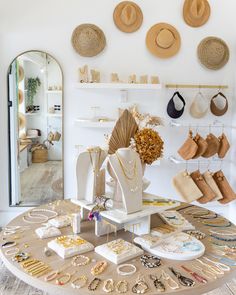 a table topped with lots of jewelry and hats