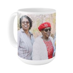 two women wearing red hats and sunglasses are standing next to each other in front of a white mug