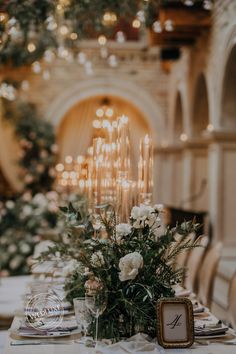 the table is set with flowers and candles